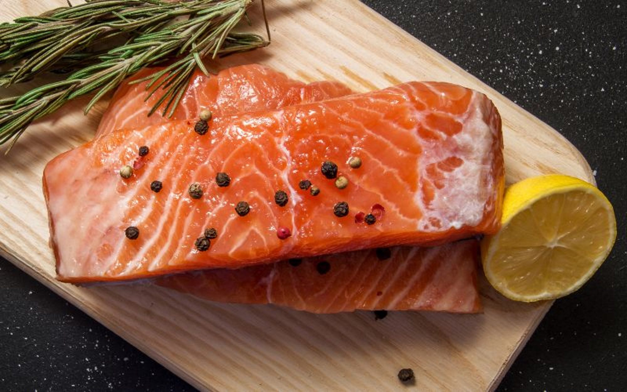 Fish - slices of salmon steaks on a cutting board