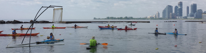 Group of kayakers learning how to kayak on the lake - photo by popular fitness