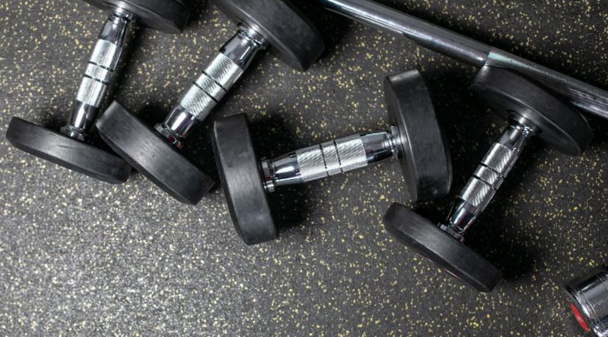 Dumbbell weights on basement gym floor.