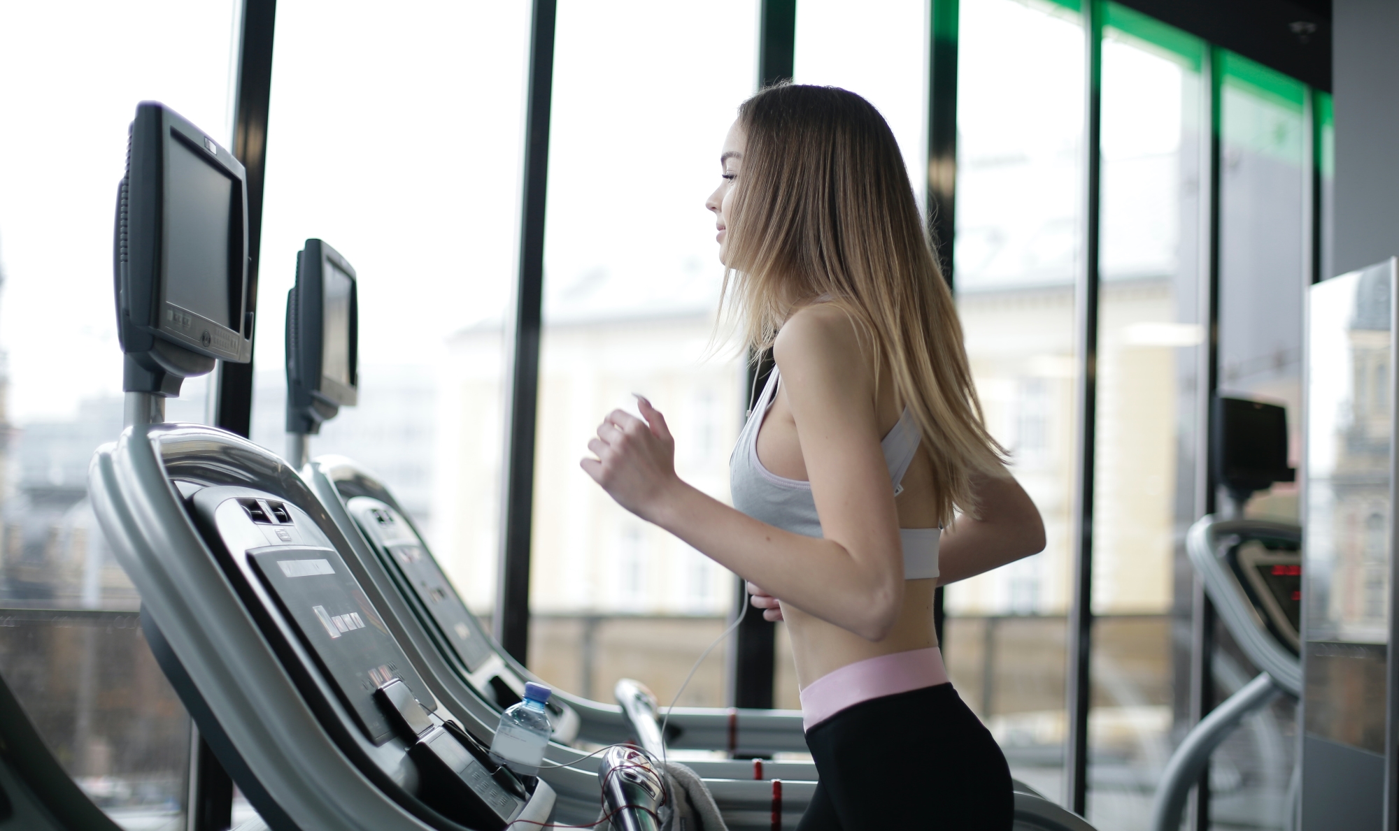 Woman exercising, running on a treadmill