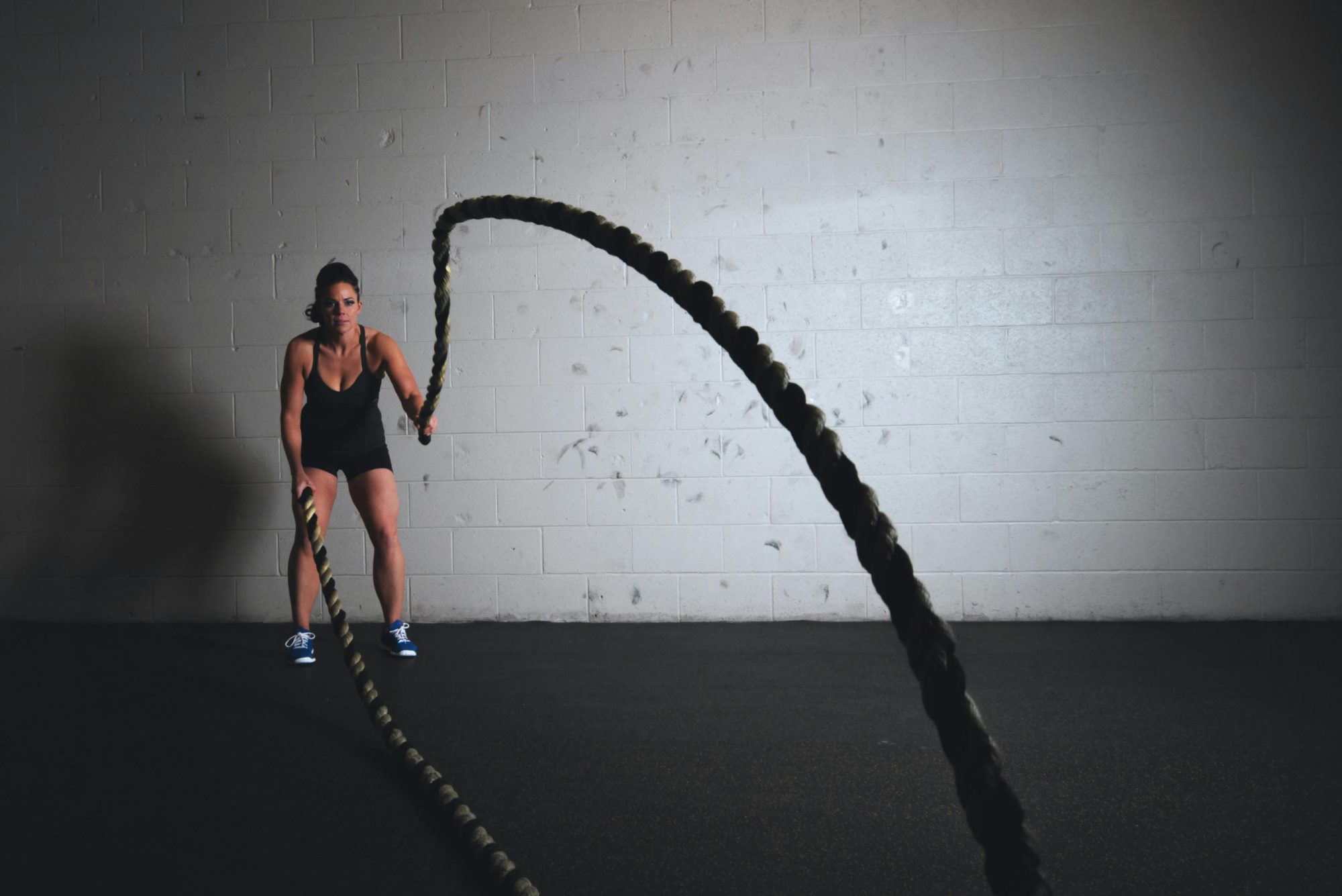 A woman doing a rope exercise workout at the gym.