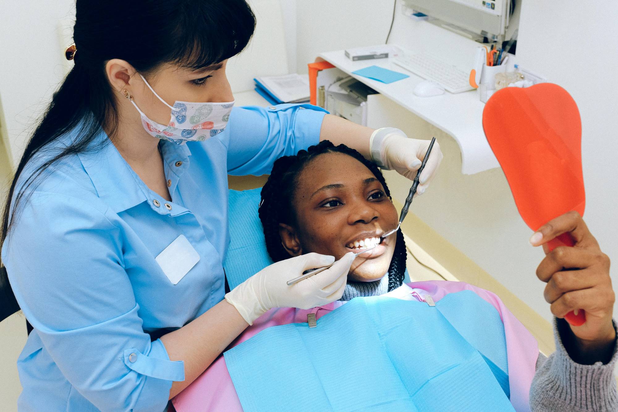 A woman getting dental care by a dentist.